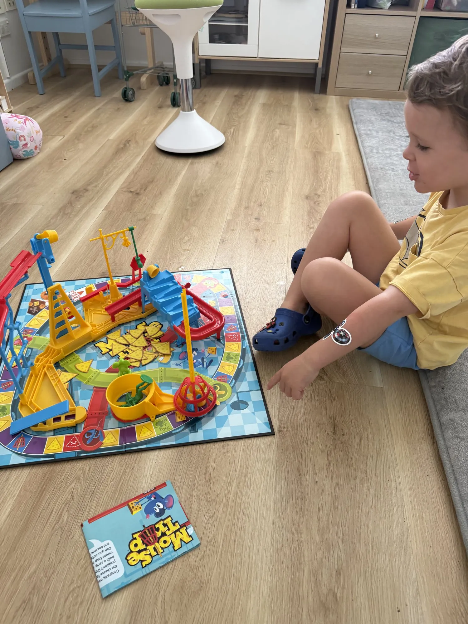 A child playing a board game on the clinic floor